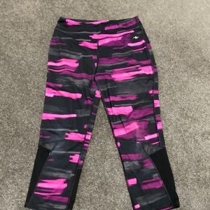 Black and pink yoga pants with mesh on the legs